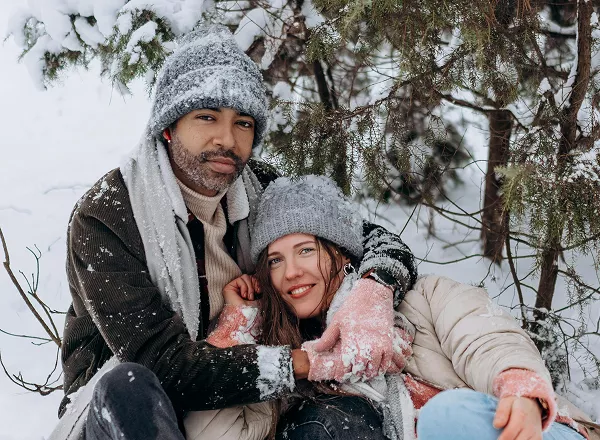 A man and woman smile warmly at the camera