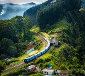 A train travels through a scenic mountain landscape