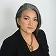 A woman with gray hair wearing a black blazer